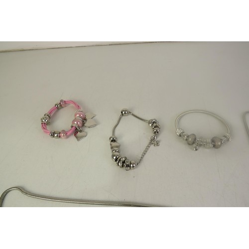 133 - Seventeen pandora style charm bracelets and charms