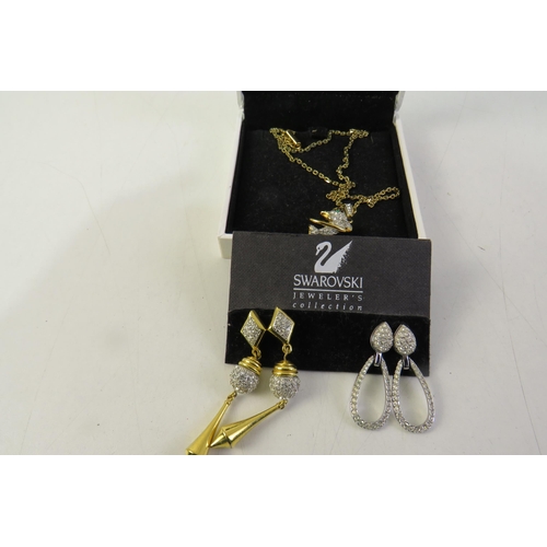 163 - Swarovski vintage gold tone dolphin necklace and two pairs of swarovski dangle earrings in presentat... 