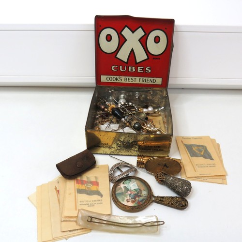 43 - Vintage Oxo tin full of ladies vanity collectables, hat pins, lipstick mirror compact, handheld mirr... 