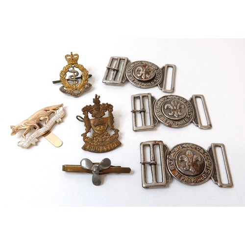 76 - Collection of Scout belt buckles, cap badge and trench art tie clip.