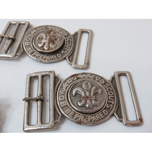 76 - Collection of Scout belt buckles, cap badge and trench art tie clip.