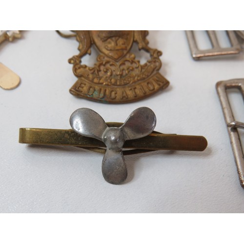 76 - Collection of Scout belt buckles, cap badge and trench art tie clip.