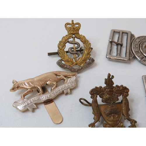 76 - Collection of Scout belt buckles, cap badge and trench art tie clip.