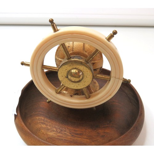 79 - A Ship's wheel nutcracker with Bakelite wheel on wooden dish.