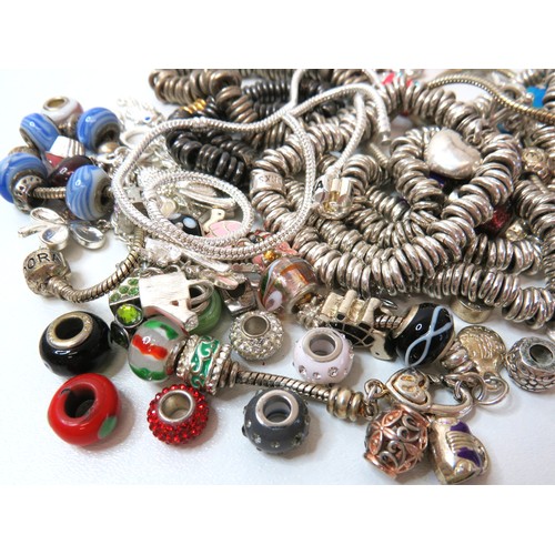 84 - Job lot of fashion charm bracelets and charms.