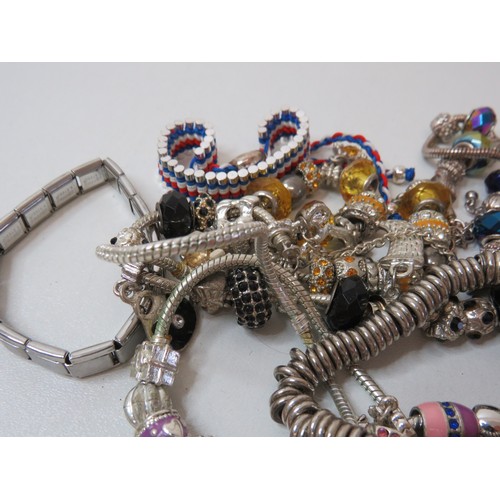 85 - Job lot of fashion charm bracelets.