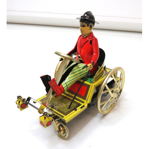 300 - Paya toys mechanical wind up tin toy man on tricycle with key in original  packet.