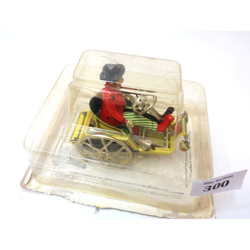 300 - Paya toys mechanical wind up tin toy man on tricycle with key in original  packet.