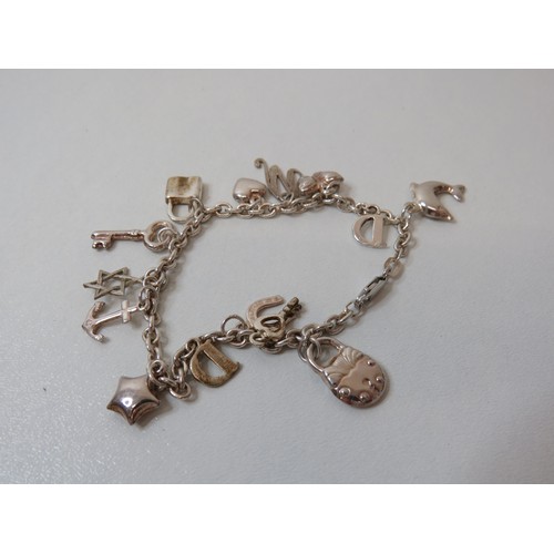 252 - Silver charm bracelet with fourteen charms