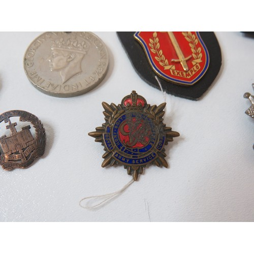 418 - Collection of cap badges including R.A.F, Silver and military postcards, WWII medals and magnifying ... 