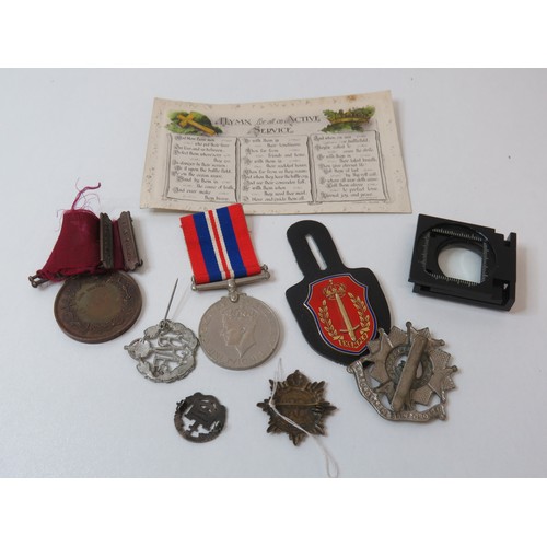 418 - Collection of cap badges including R.A.F, Silver and military postcards, WWII medals and magnifying ... 