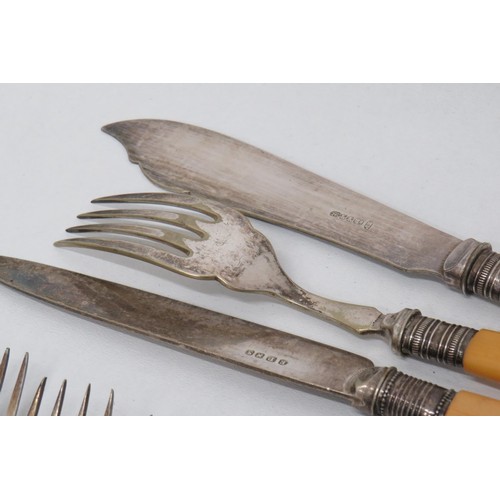 220 - Fish knifes and forks silver rimmed