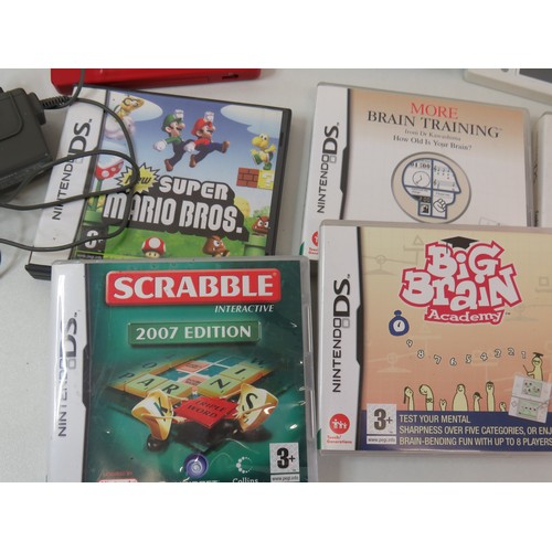 64 - Three Nintendo DS consoles with one charger and games including Super Mario Brothers.