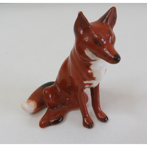 38 - Small and large size Beswick Fox figurines.