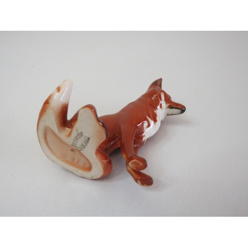 38 - Small and large size Beswick Fox figurines.