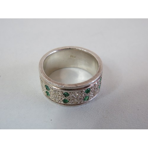 220 - 950 Platinum band ring set with diamonds & emeralds size V, weight 18g.