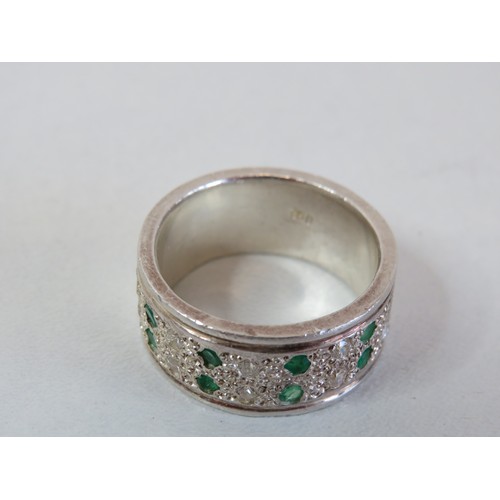 220 - 950 Platinum band ring set with diamonds & emeralds size V, weight 18g.