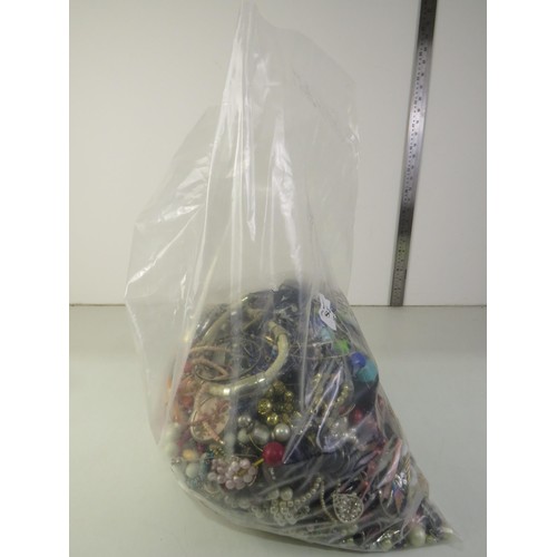 82 - 10kg bag of unsorted costume Jewellery.