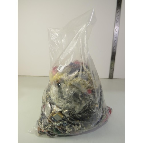 83 - 10kg bag of unsorted costume Jewellery.