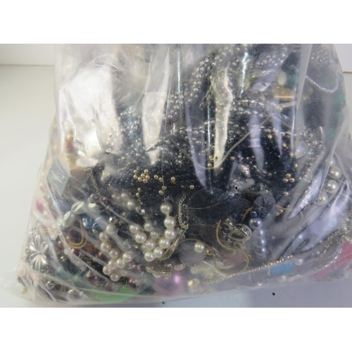 83 - 10kg bag of unsorted costume Jewellery.