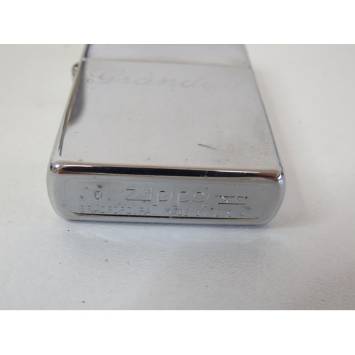 220 - Zippo lighter and a hipflask