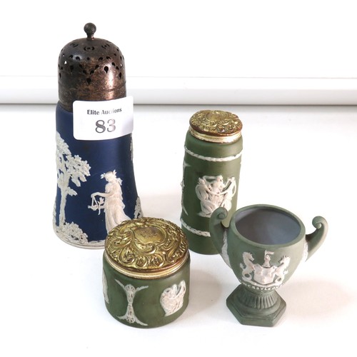 83 - Four Antique Wedgewood Jasperware items includes blue sugar shaker, two green lidded pots and Newcas... 