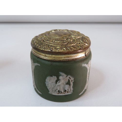 83 - Four Antique Wedgewood Jasperware items includes blue sugar shaker, two green lidded pots and Newcas... 