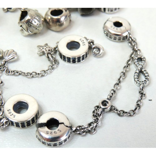 291 - Job lot of assorted 925 silver bracelet charms to include Pandora.