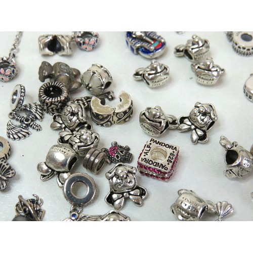 291 - Job lot of assorted 925 silver bracelet charms to include Pandora.