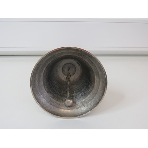 299 - Large white metal wooden handled handbell, height 28.5cms.