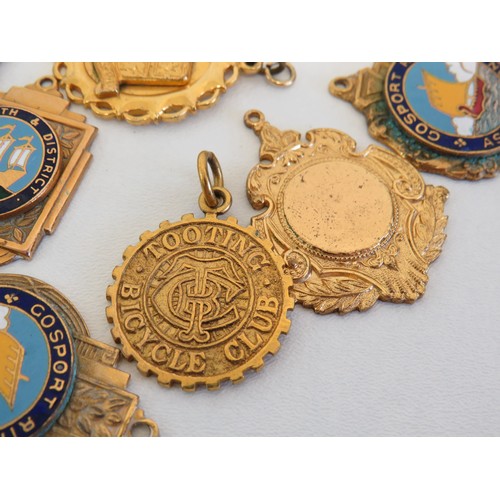 90 - Collection of gold tone medals and fobs.