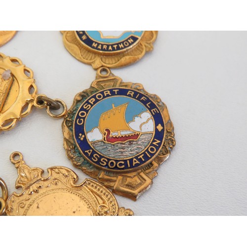 90 - Collection of gold tone medals and fobs.