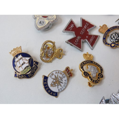 Fifteen assorted pin badges including military