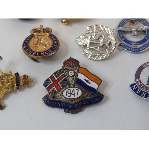 Fifteen assorted pin badges including military