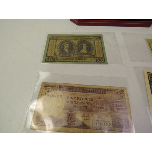 Red mint case and contents including coins and notes
