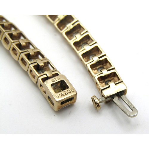 75B - A 9ct yellow gold tennis bracelet set with 2ct of Princess cut square Diamonds.
Weight 14.8g
Length ... 
