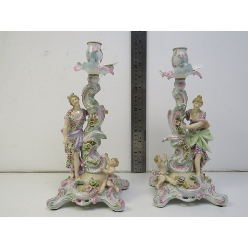 32 - A pair of 19th century Dresden porcelain figural candlesticks.