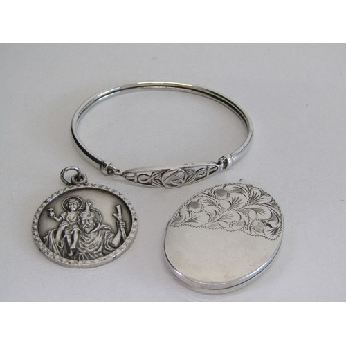 46 - 3 925% Silver hall marked items. A large locket, St Christopher, a Celtic designed braclet.