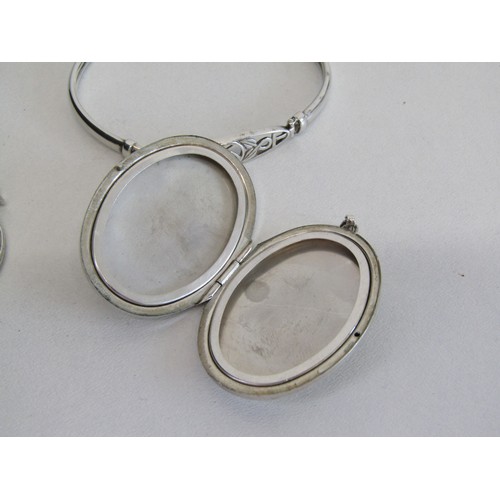 46 - 3 925% Silver hall marked items. A large locket, St Christopher, a Celtic designed braclet.