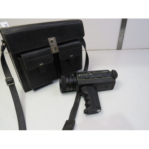111 - Bell & Howell camera 2148 - camera, bag and books.