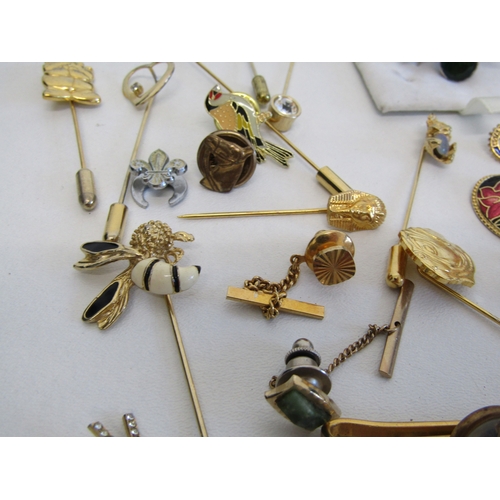 69 - A collection of vintage stick pins, hat pins and tie clips.