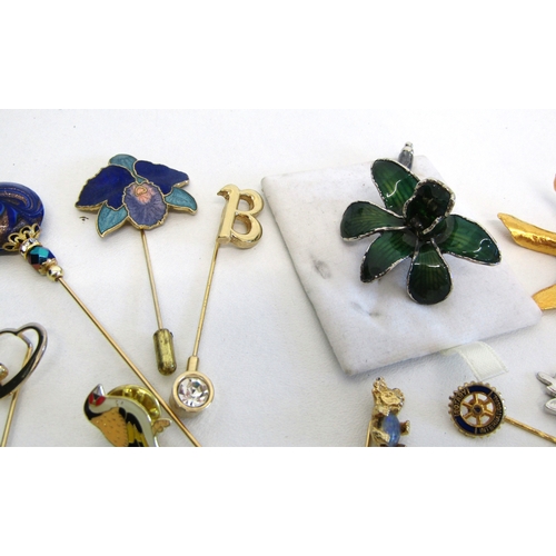 69 - A collection of vintage stick pins, hat pins and tie clips.