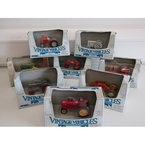 100 - A collection of eight boxed Ertl diecast metal tractors.
