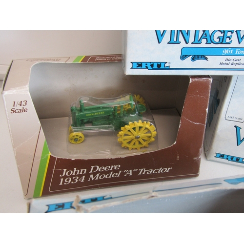 100 - A collection of eight boxed Ertl diecast metal tractors.