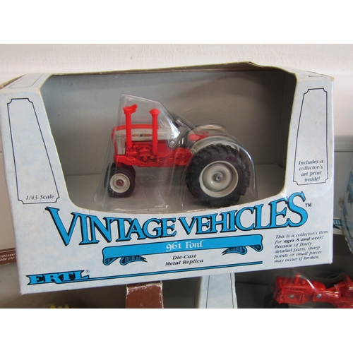 100 - A collection of eight boxed Ertl diecast metal tractors.