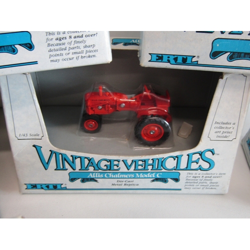 100 - A collection of eight boxed Ertl diecast metal tractors.