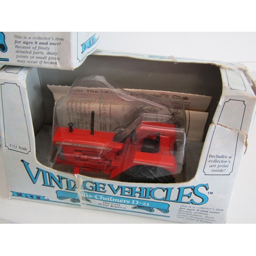 100 - A collection of eight boxed Ertl diecast metal tractors.