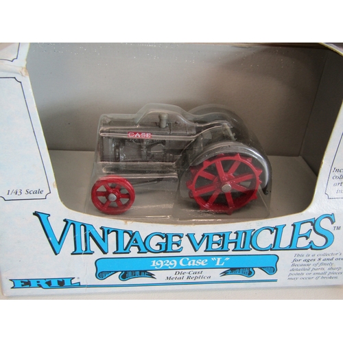 100 - A collection of eight boxed Ertl diecast metal tractors.