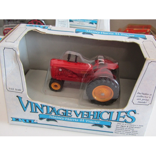 100 - A collection of eight boxed Ertl diecast metal tractors.