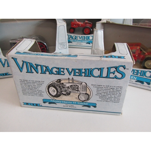 100 - A collection of eight boxed Ertl diecast metal tractors.